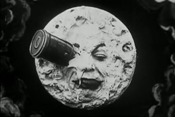 Screenshot from the 1902 A Trip to the Moon movie by George Melies of a rocket hitting a man in the moon face