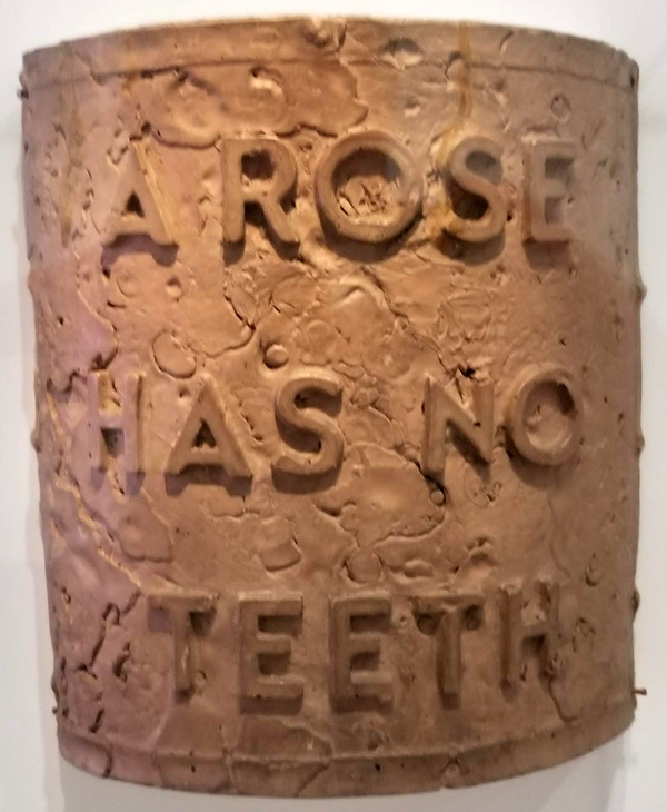 Cast iron plaque, A ROSE HAS NO TEETH, by Bruce Nauman