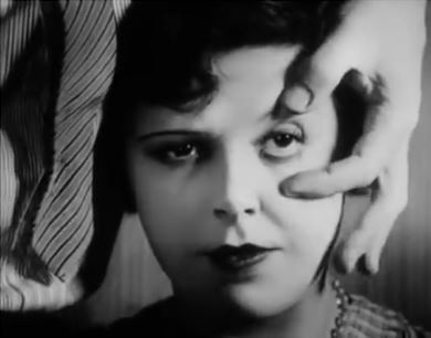 A screen shot of a man about to supposedly cut a woman's eye with a straight razor from the 1929 Un Chien Andalou movie by Salavador Dali and Luis Bunuel